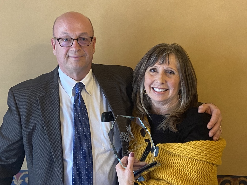 two people with an award