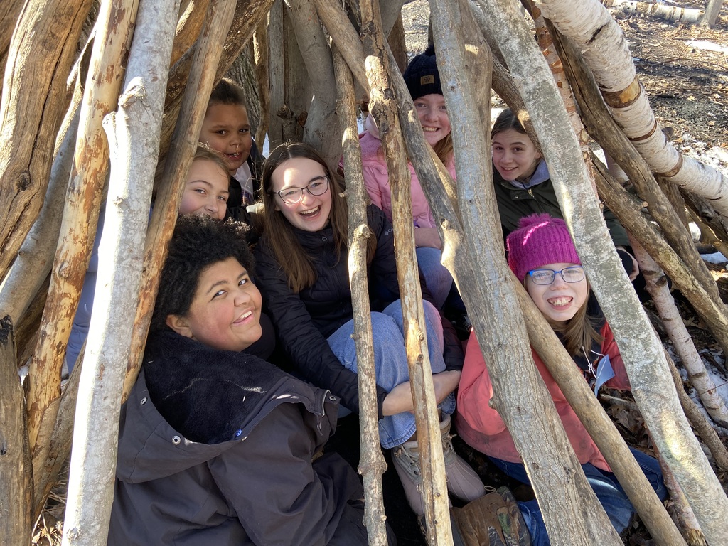 students in wood shelter