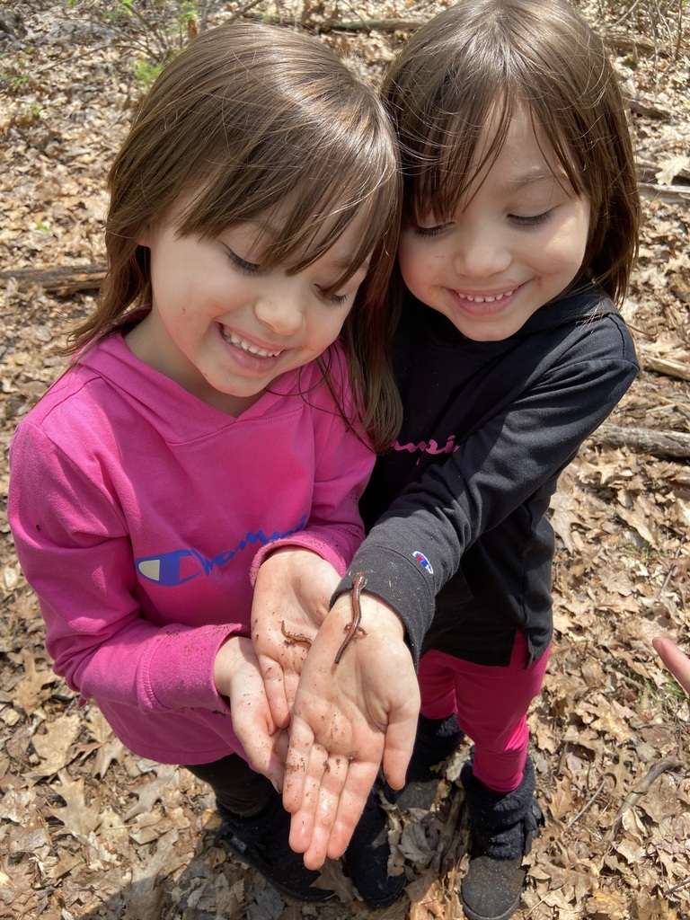 two girls holding salamander